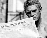 PORTRAIT OF STEVE MCQUEEN READING THE WALL STREET JOURNAL, 1967