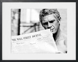 PORTRAIT OF STEVE MCQUEEN READING THE WALL STREET JOURNAL, 1967